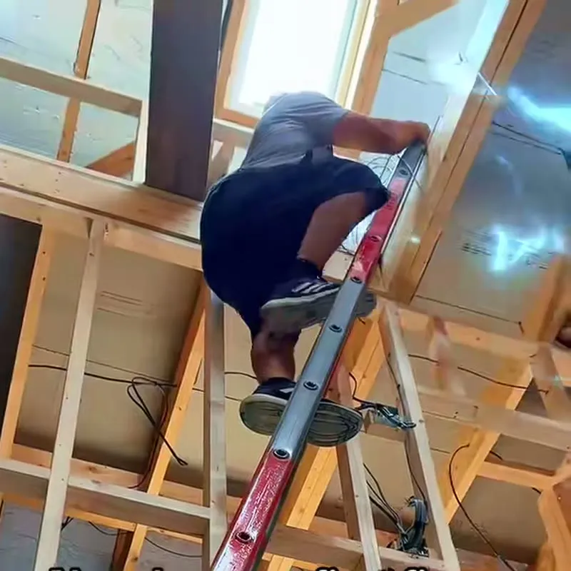Cables run through the open timber joists of a new-build house before plastering