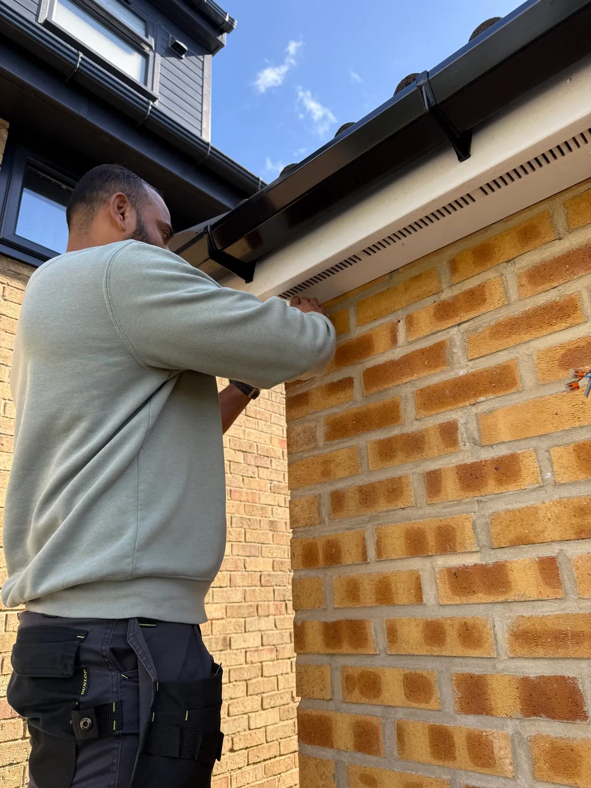 Mitu fixing a turret camera base under the soffit, brick wall, no cable on show